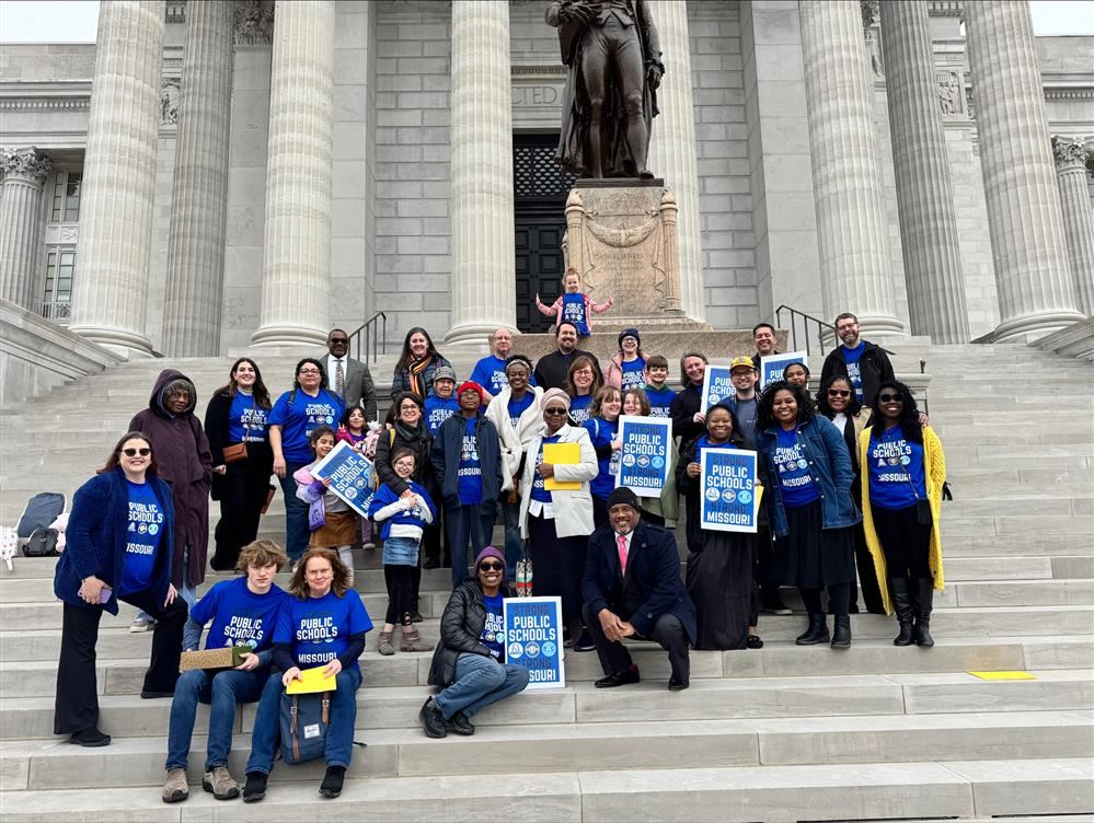  A large group of diverse individuals, including parents, students, SLPS staff, and community member